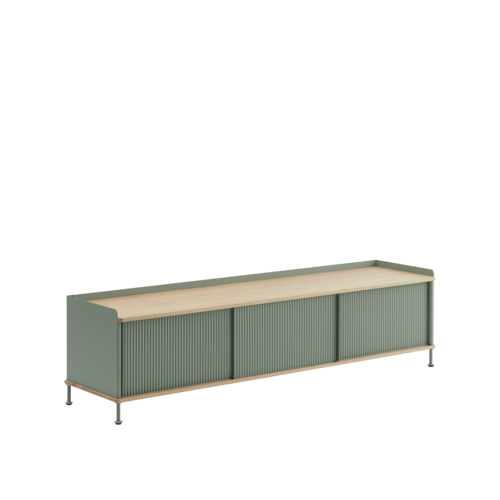 The Enfold Sideboard combines industrial materiality with residential references for a new perspective on modern storage. Made from a lacquered steel that gently enfolds its top and bottom in solid oak, the Enfold Sideboard fuses cold and warm materials for a unique expression, paired with the vibrantly modern expression of its ridged steel doors. The flexible design is available in four sizes, which all have adjustable shelves and discreet cable outlets. This offers the opportunity to find just the right fit for your space, function and needs — be it a media console, in the hallway or a tall sideboard for storage.